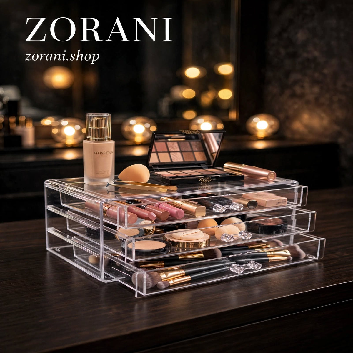 A clear acrylic multi-tier makeup organizer filled with cosmetics, shown on a dark wooden table in a softly lit vanity setting. The ZORANI brand logo is visible in the top left corner.